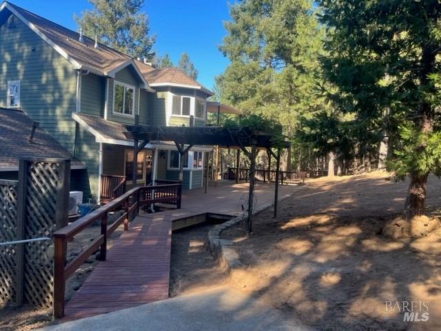 view of front of house with a pergola and a wooden deck