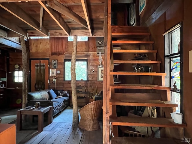 interior space featuring wood walls, dark wood-type flooring, and a wealth of natural light