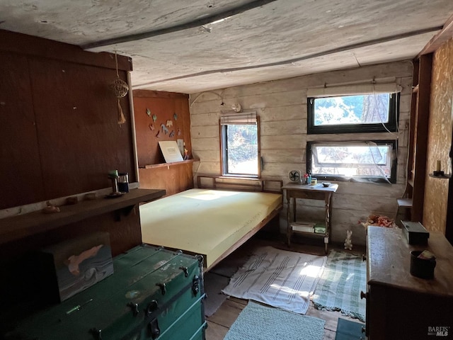 bedroom featuring wood walls