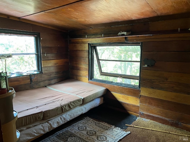 bedroom featuring wood ceiling, wood walls, and vaulted ceiling