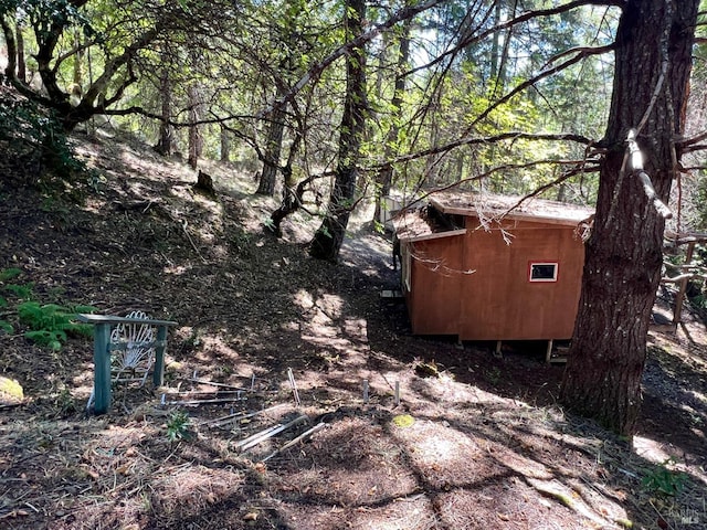 view of property exterior with a storage shed