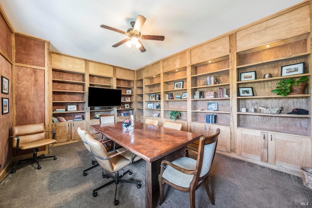 office with built in features, dark colored carpet, and ceiling fan