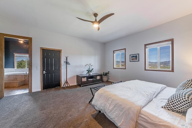 bedroom with connected bathroom, carpet flooring, and ceiling fan