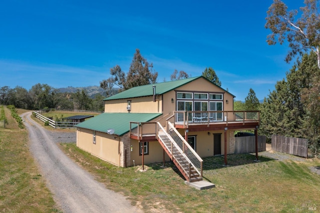 exterior space with a wooden deck and a front yard