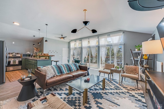 living room featuring sink, ceiling fan, and light wood-type flooring