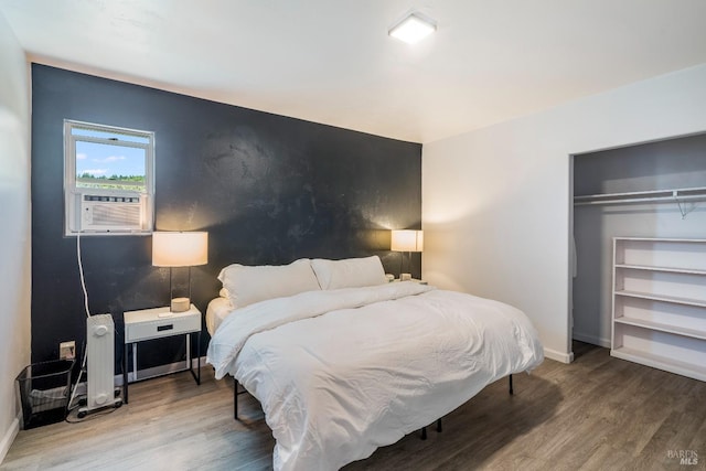 bedroom with a closet and hardwood / wood-style flooring