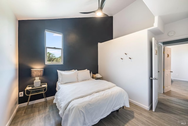 bedroom with vaulted ceiling, ceiling fan, and wood-type flooring