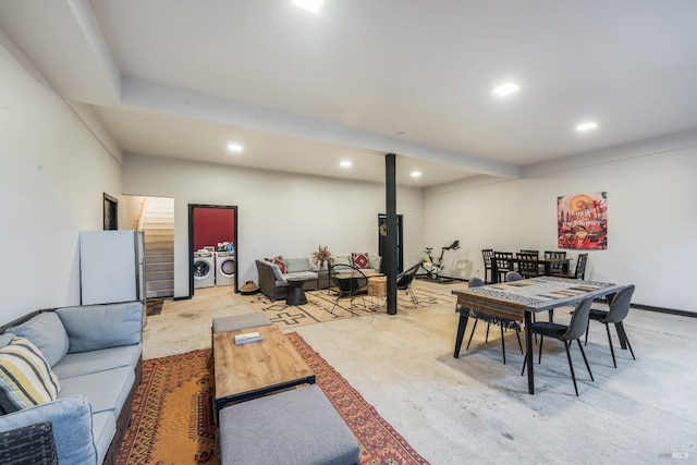 dining space with a wood stove and independent washer and dryer