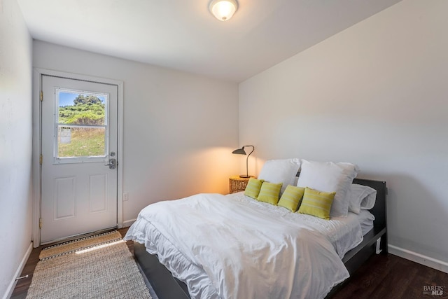 bedroom with dark hardwood / wood-style floors