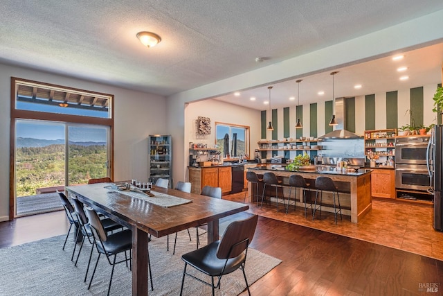 tiled dining room featuring a textured ceiling