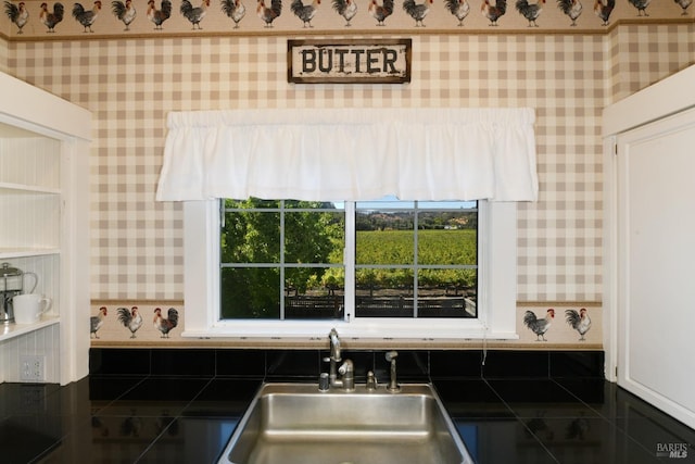 kitchen with tile patterned floors, white cabinetry, and sink