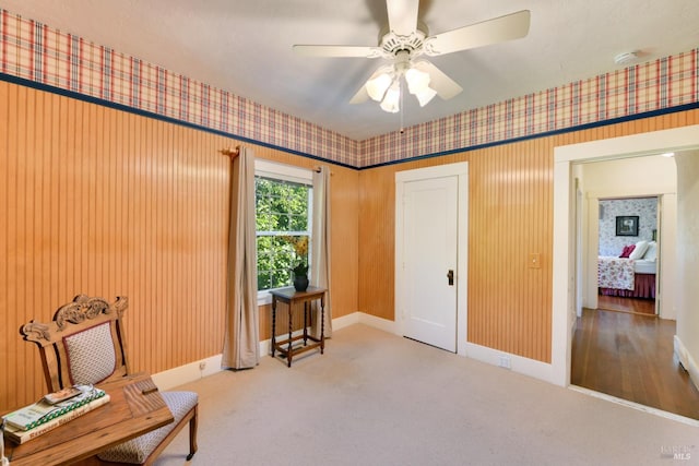 sitting room featuring ceiling fan and carpet