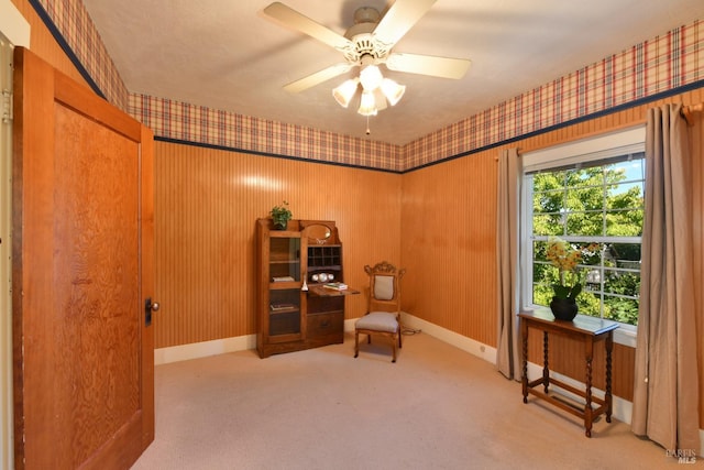 living area featuring ceiling fan and light colored carpet