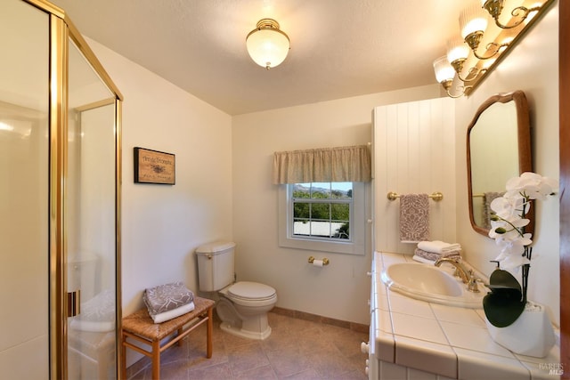 bathroom with tile patterned floors, vanity, toilet, and an enclosed shower