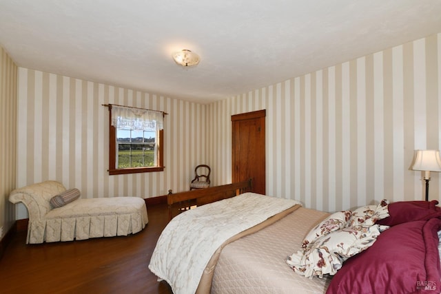 bedroom with dark hardwood / wood-style floors