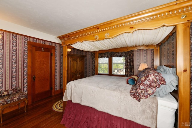 bedroom with dark hardwood / wood-style flooring