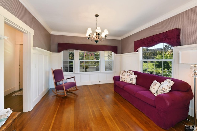 living room with hardwood / wood-style floors, a chandelier, and ornamental molding