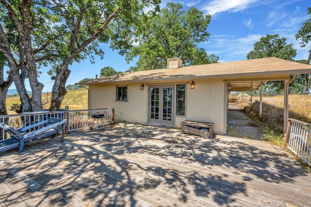 back of house with a deck and french doors