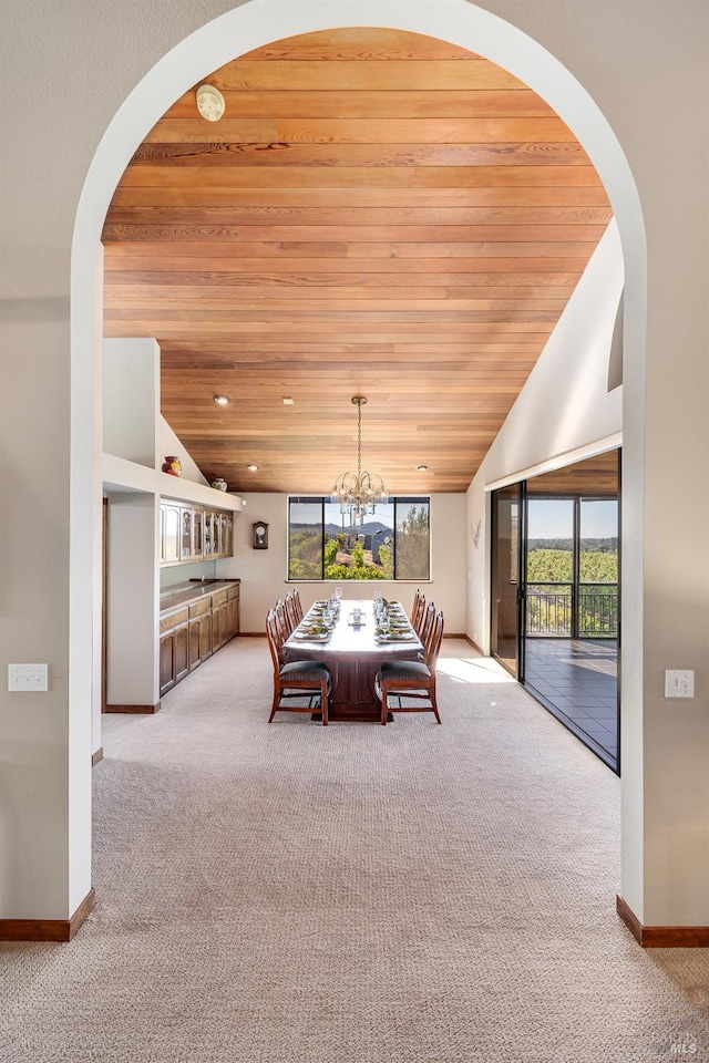 unfurnished bedroom with wooden ceiling, a notable chandelier, lofted ceiling, and light colored carpet