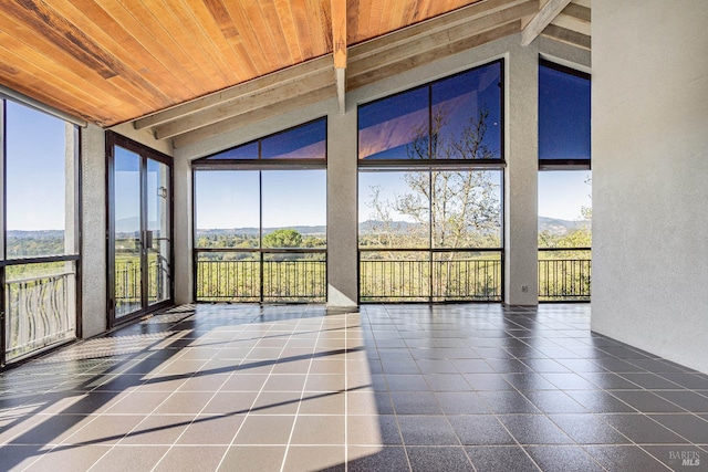 unfurnished sunroom featuring lofted ceiling, a wealth of natural light, and wooden ceiling