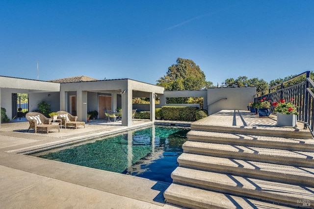 view of swimming pool with a patio