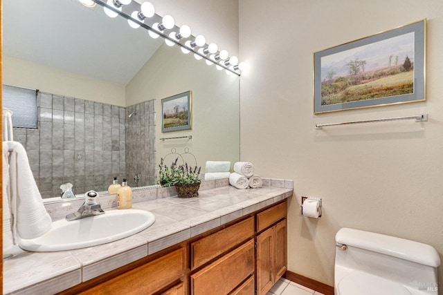 bathroom featuring lofted ceiling, large vanity, and toilet