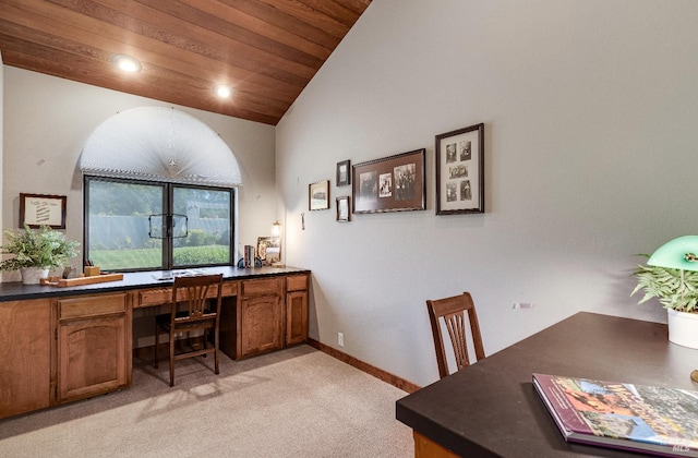 office area featuring light carpet and vaulted ceiling