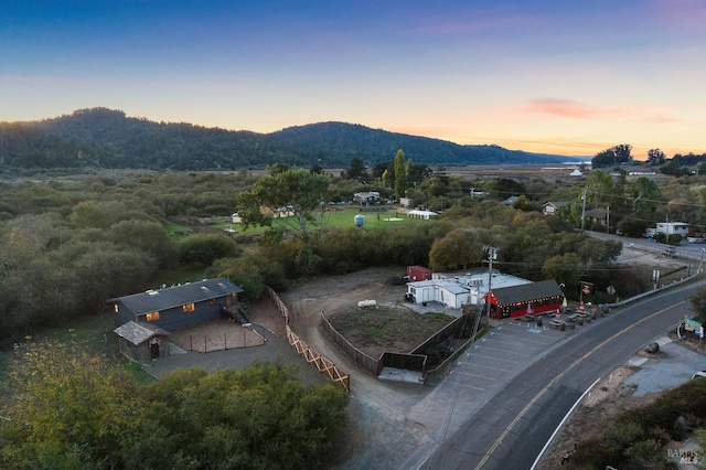 aerial view at dusk featuring a mountain view