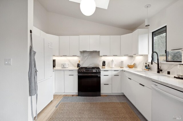 kitchen featuring white cabinets, dishwasher, backsplash, and black range with gas stovetop