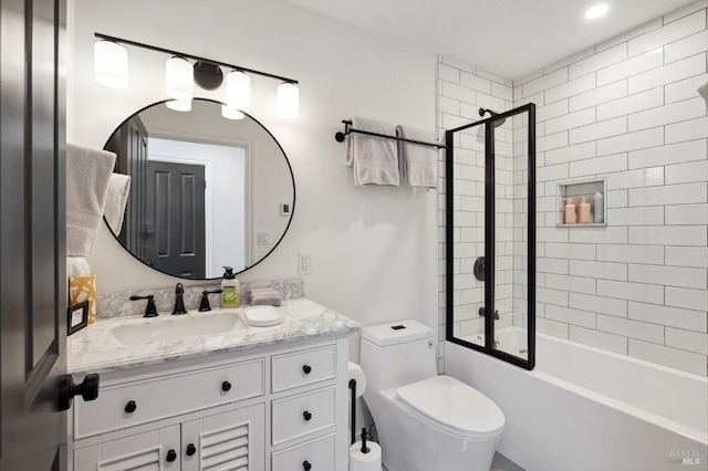 full bathroom with oversized vanity, toilet, and enclosed tub / shower combo