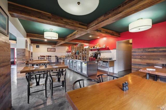 dining room featuring coffered ceiling and beamed ceiling