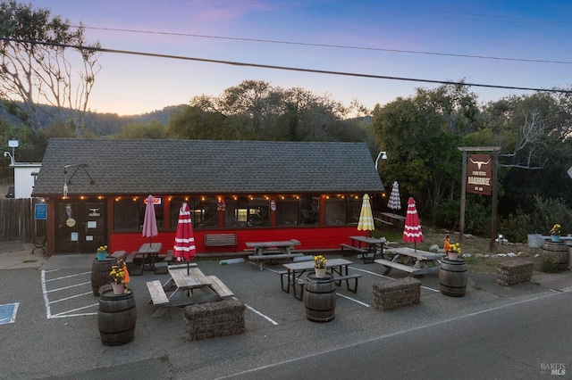 patio terrace at dusk featuring an outdoor fire pit