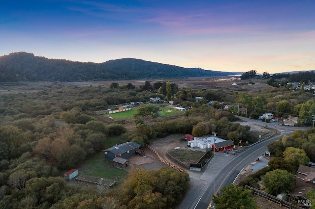 aerial view at dusk featuring a mountain view