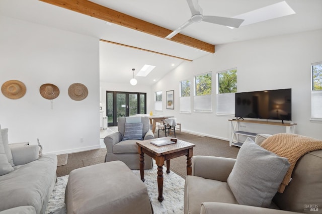 carpeted living room featuring lofted ceiling with skylight, ceiling fan, and french doors