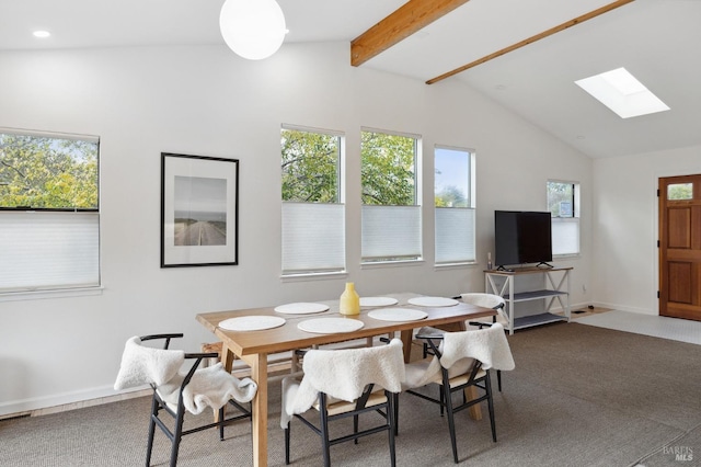 dining area featuring vaulted ceiling with skylight and dark carpet