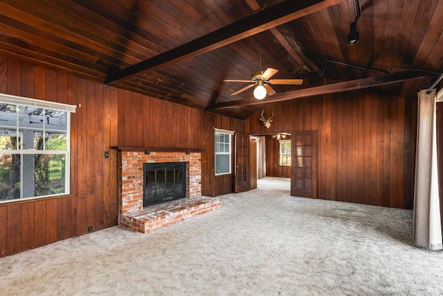 unfurnished living room featuring wooden walls, carpet floors, and wooden ceiling