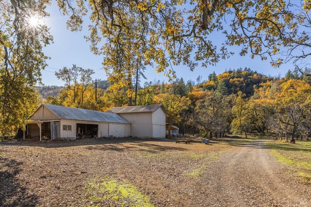 ranch-style home with an outbuilding and a carport