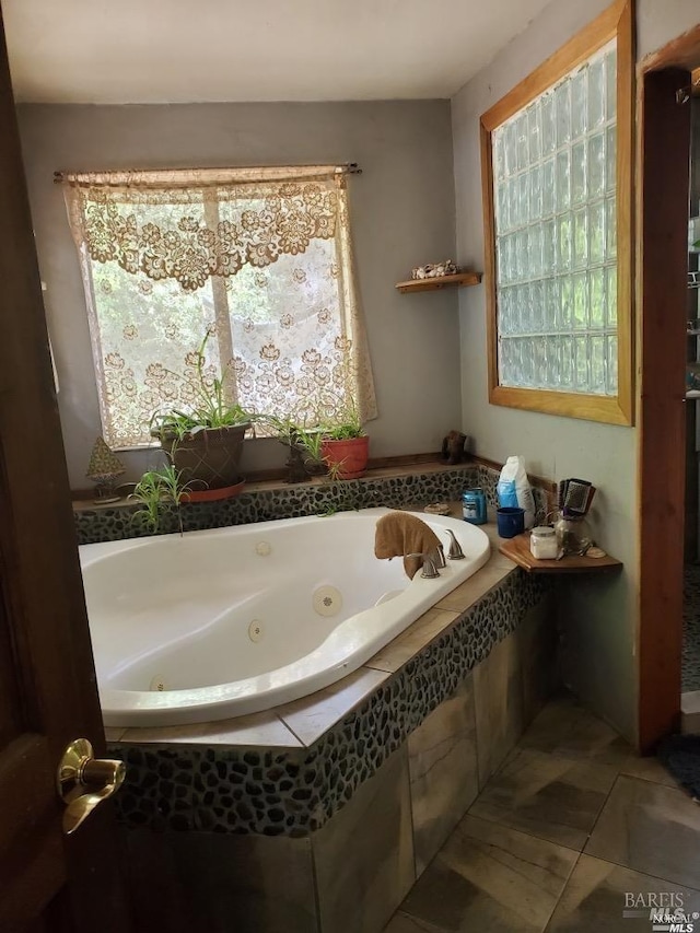 bathroom featuring tiled tub and tile patterned flooring