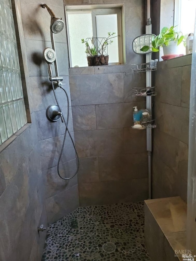 bathroom with tiled shower