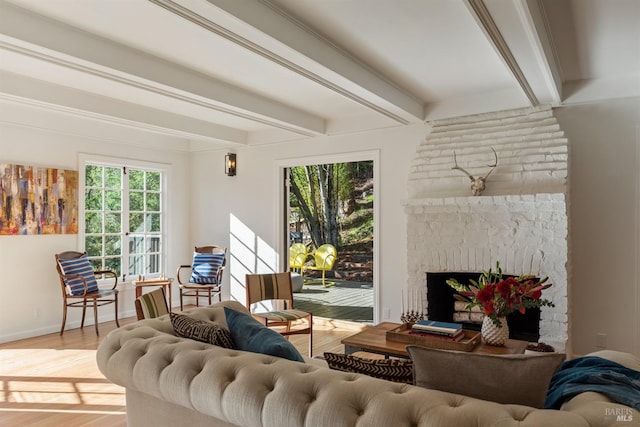 living room featuring beam ceiling, a fireplace, and hardwood / wood-style floors