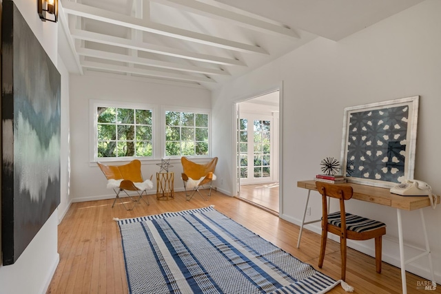 office with light wood-type flooring and beam ceiling