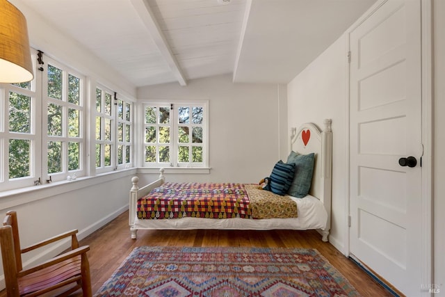 bedroom with dark hardwood / wood-style flooring, multiple windows, and lofted ceiling with beams