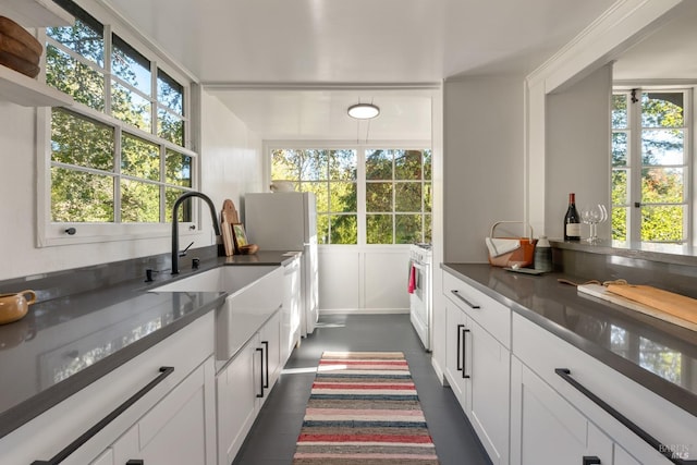 kitchen with sink, white cabinetry, dark hardwood / wood-style flooring, and white appliances