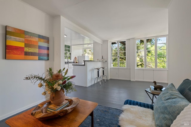 living room with dark hardwood / wood-style floors and beamed ceiling