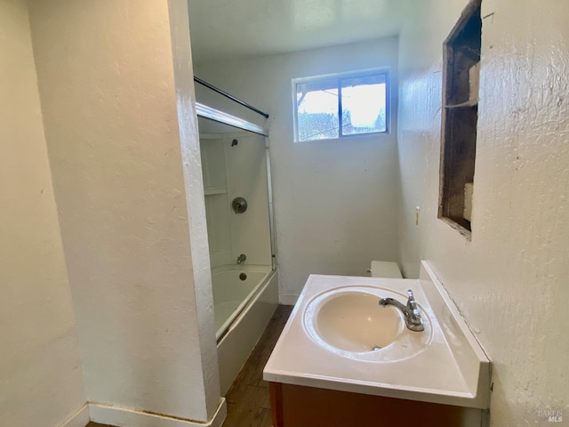 full bathroom with shower / washtub combination, vanity, toilet, and hardwood / wood-style floors