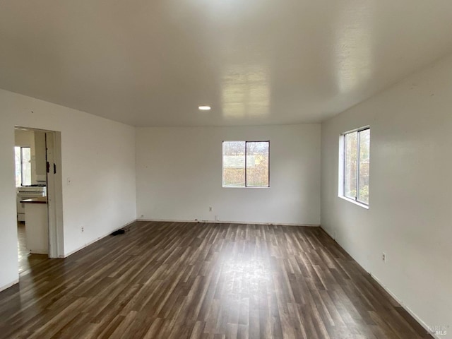 empty room with dark wood-type flooring