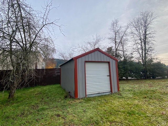 view of outbuilding featuring a lawn