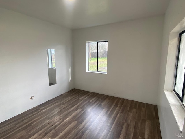 unfurnished room with dark hardwood / wood-style floors