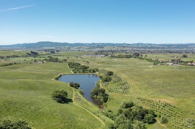 drone / aerial view featuring a water and mountain view and a rural view