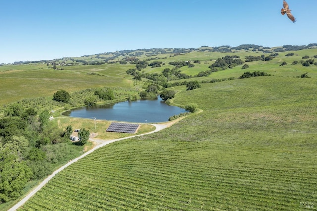 aerial view with a rural view and a water view